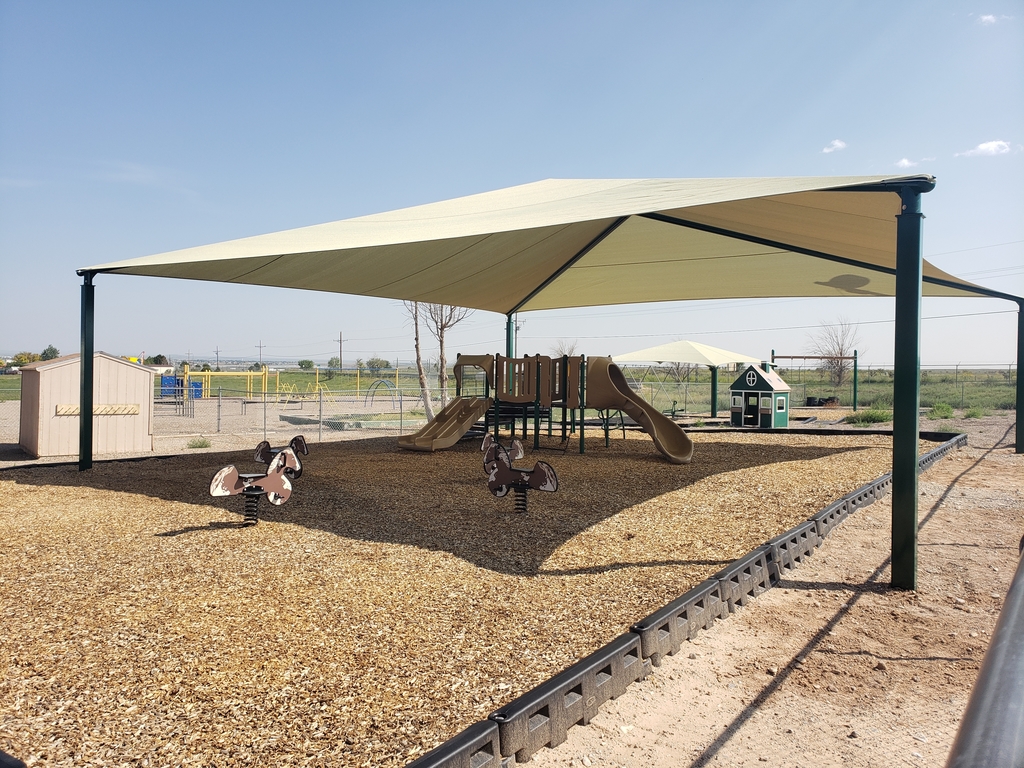 Playground with completed shades, playhouse, Pintos, and play structure.