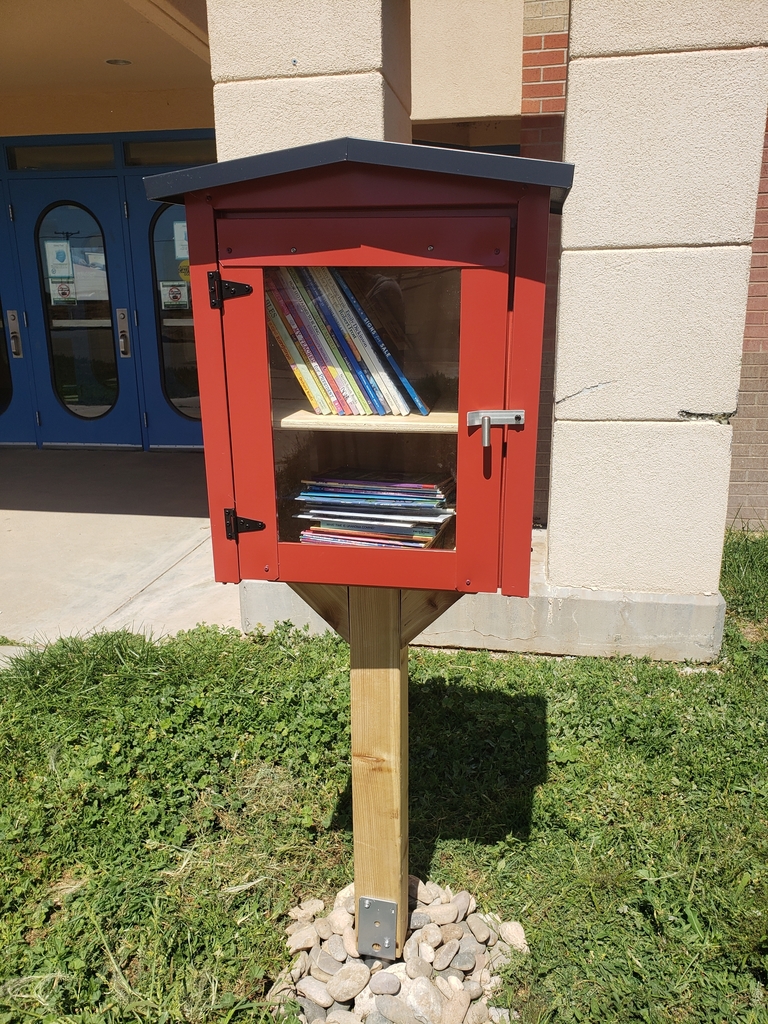 Red Little Free Library with books.